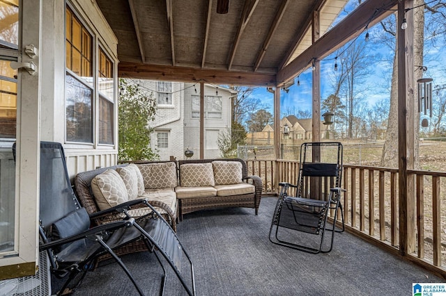 sunroom with lofted ceiling with beams