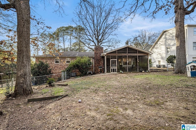 back of house featuring a sunroom