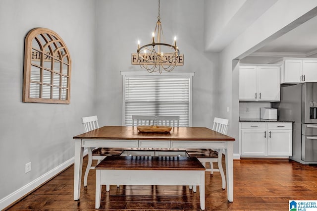 dining space with dark hardwood / wood-style flooring, crown molding, and a chandelier