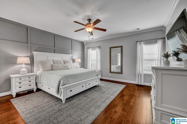 bedroom with multiple windows, dark hardwood / wood-style flooring, ceiling fan, and crown molding