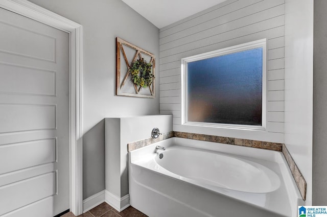 bathroom featuring tile patterned floors and a tub