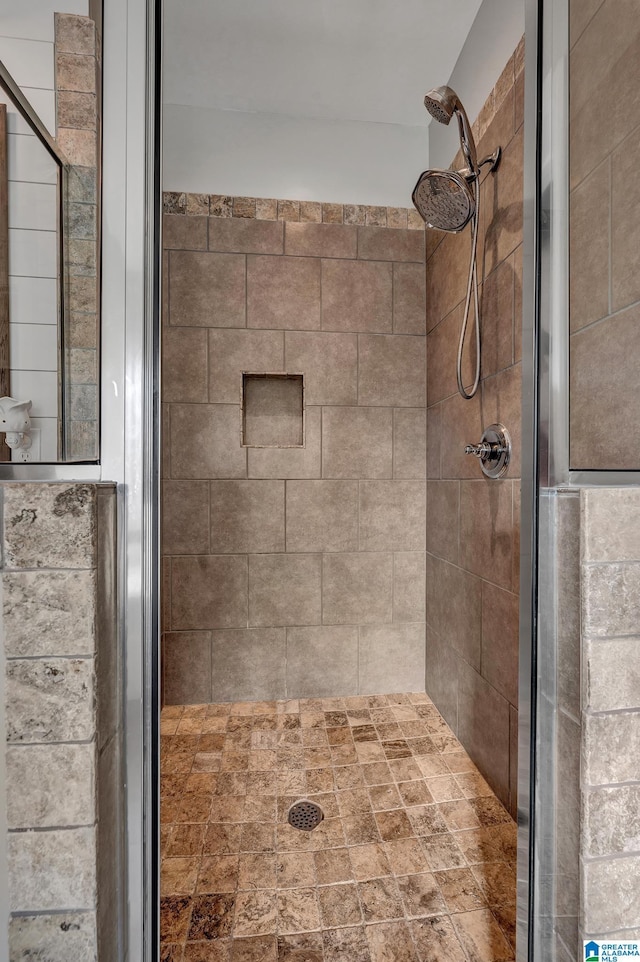 bathroom featuring a shower with shower door