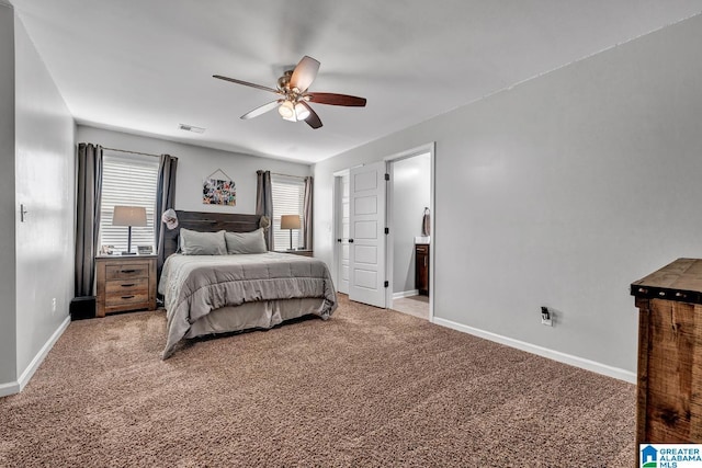 carpeted bedroom featuring ensuite bath and ceiling fan