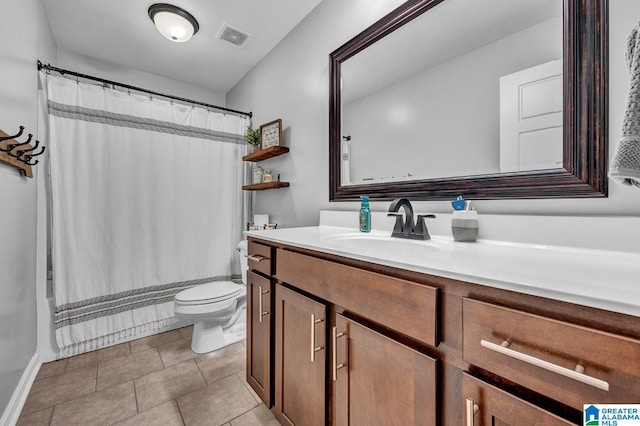 bathroom featuring tile patterned flooring, vanity, and toilet