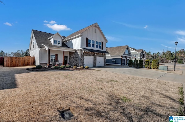 view of front of property with covered porch, a garage, and a front lawn