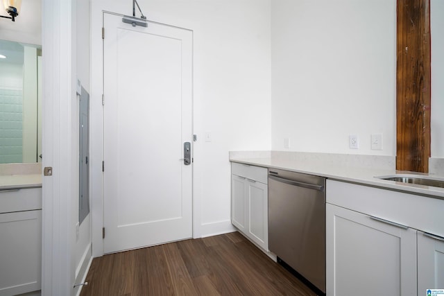 kitchen featuring stainless steel dishwasher, white cabinetry, and dark wood-type flooring