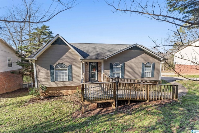 view of front of house with a deck and a front yard