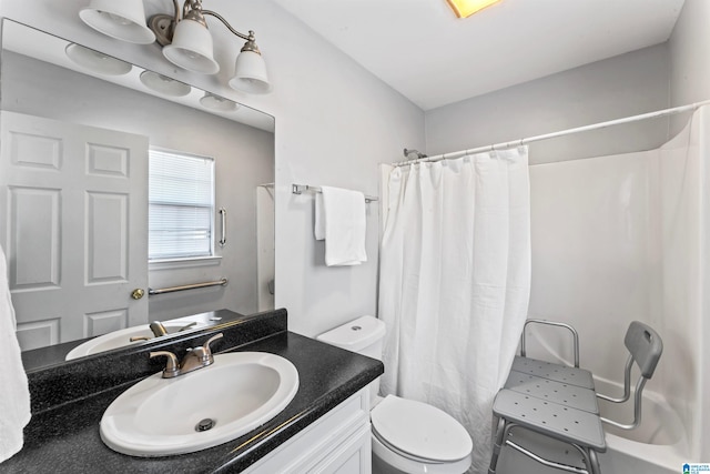 bathroom with toilet, vanity, and a shower with shower curtain