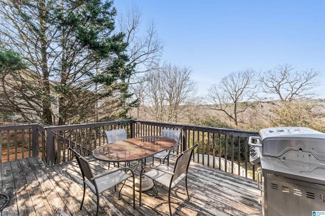 wooden deck with a grill