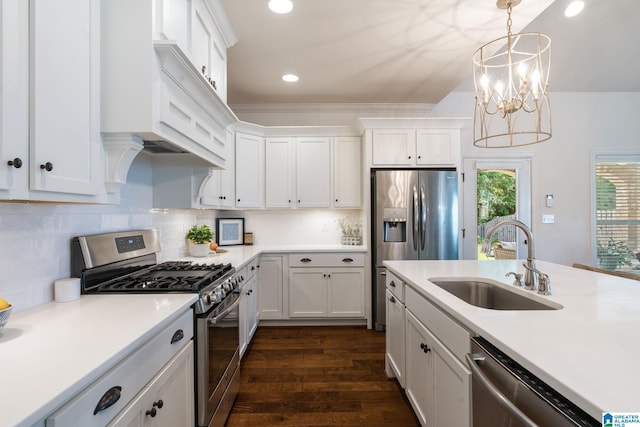 kitchen featuring sink, an inviting chandelier, decorative backsplash, white cabinets, and appliances with stainless steel finishes