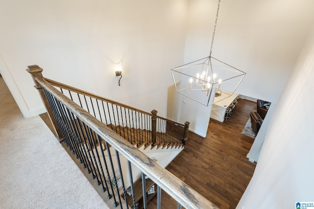 staircase with an inviting chandelier