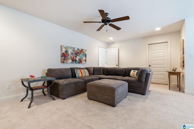 carpeted living room with ceiling fan