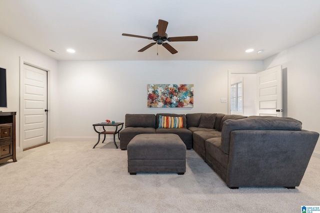 living room featuring ceiling fan and light colored carpet