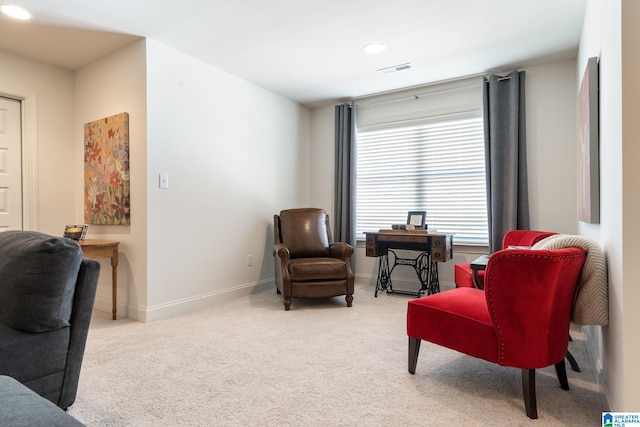 sitting room featuring light carpet