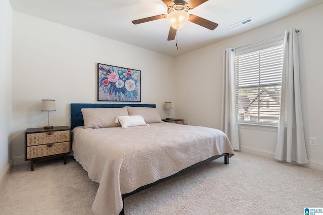 bedroom featuring ceiling fan and light carpet