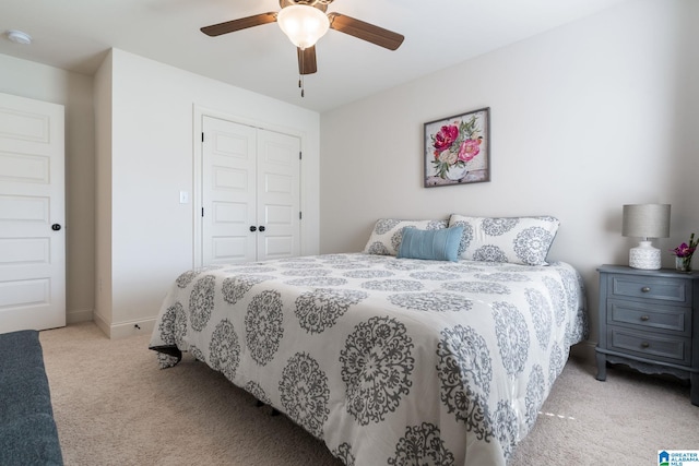 carpeted bedroom featuring a closet and ceiling fan