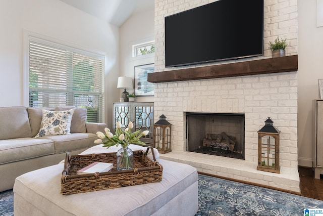 living room with dark hardwood / wood-style floors, a fireplace, and vaulted ceiling