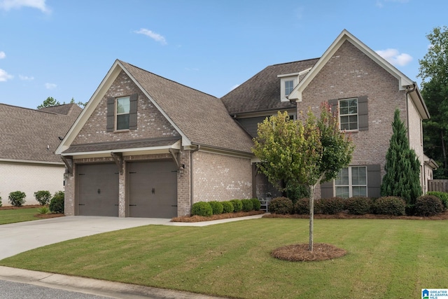 view of front of house with a garage and a front lawn