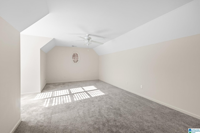 bonus room with ceiling fan, light carpet, and lofted ceiling