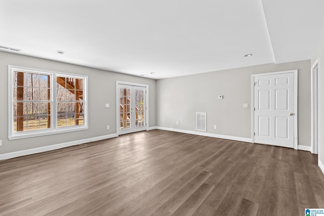 unfurnished room featuring hardwood / wood-style flooring and a healthy amount of sunlight