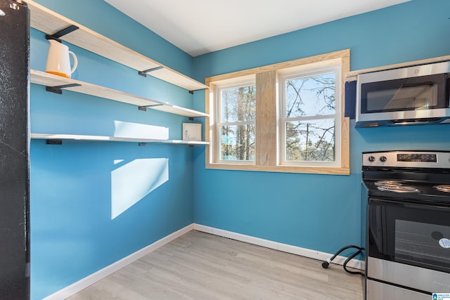 washroom with light wood-type flooring