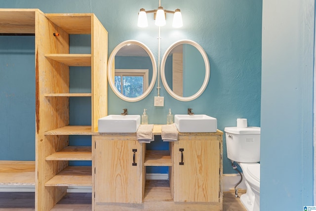 bathroom with vanity, toilet, and wood-type flooring