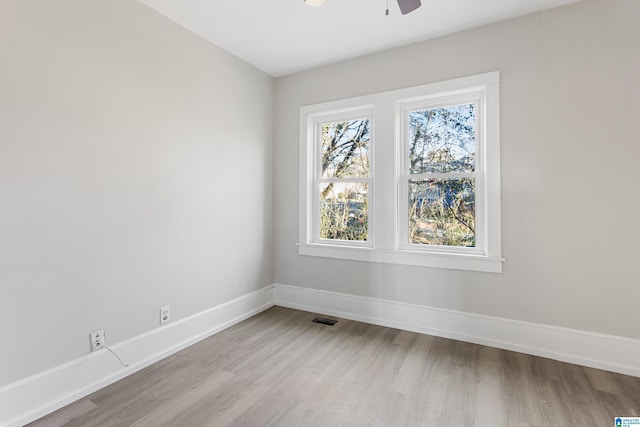 spare room featuring ceiling fan and light wood-type flooring