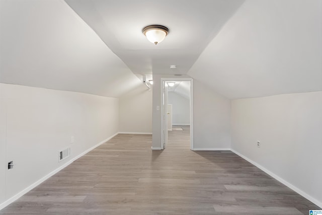 bonus room featuring light hardwood / wood-style flooring and lofted ceiling