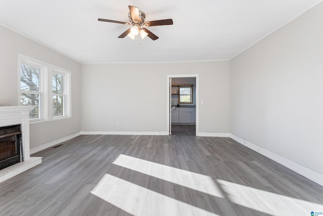 unfurnished living room with hardwood / wood-style floors and ceiling fan