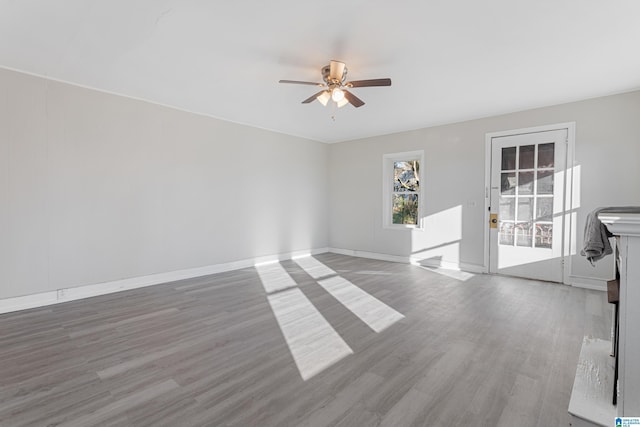 interior space with ceiling fan and light hardwood / wood-style floors