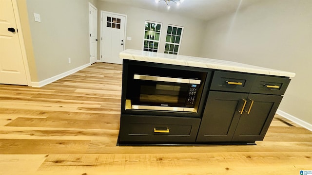 bar with light wood-type flooring