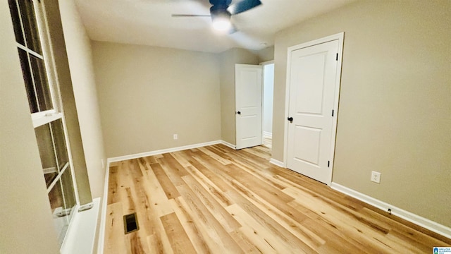 unfurnished room featuring hardwood / wood-style floors and ceiling fan