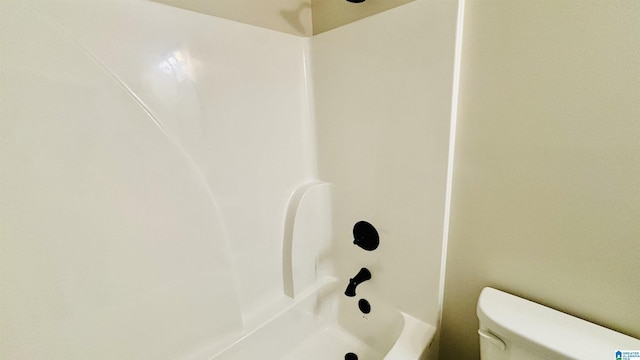 bathroom with shower / bath combination and toilet