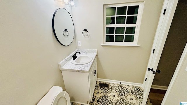 bathroom with tile patterned floors, vanity, and toilet