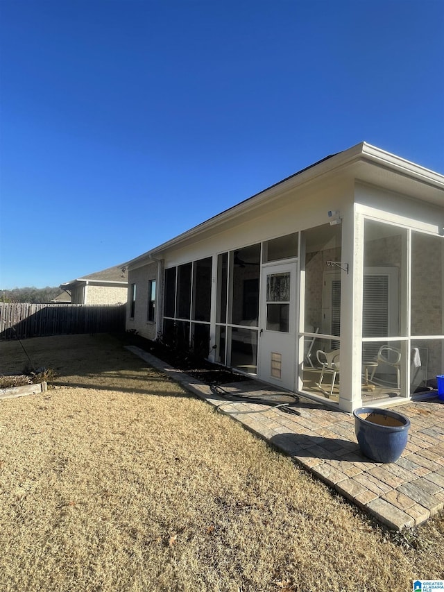 rear view of property featuring a sunroom