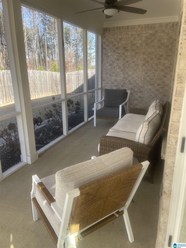 sunroom / solarium featuring ceiling fan