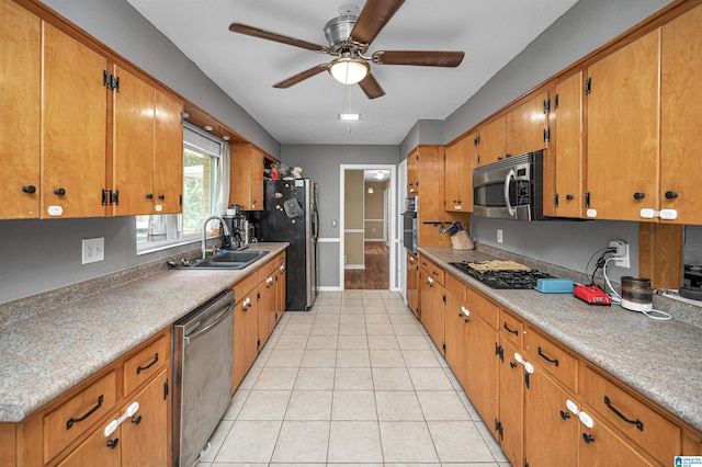 kitchen featuring black appliances, ceiling fan, light tile patterned floors, and sink