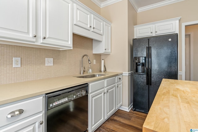 kitchen with black appliances, butcher block countertops, sink, white cabinetry, and backsplash