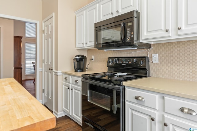 kitchen featuring backsplash, white cabinetry, wooden counters, and black appliances