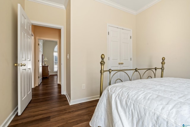 bedroom featuring ornamental molding, dark hardwood / wood-style flooring, and a closet