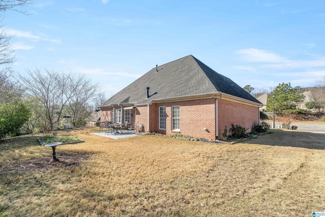 back of house with a patio and a yard