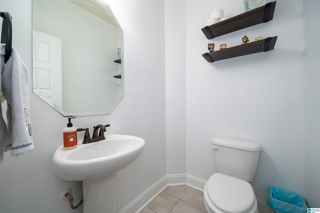 bathroom featuring tile patterned flooring, toilet, and sink