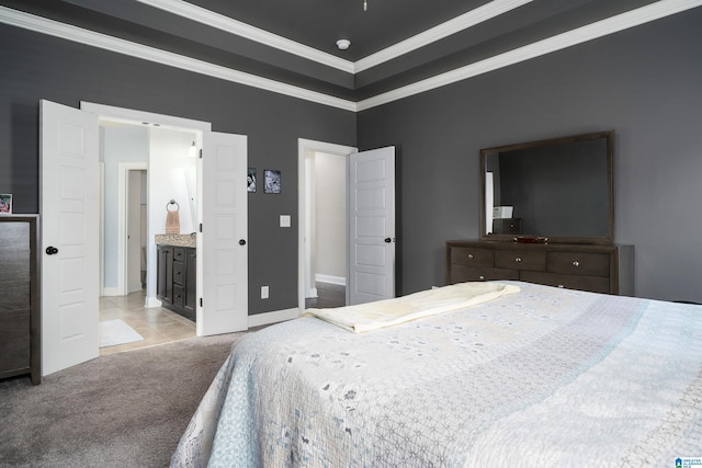 bedroom with light colored carpet, ensuite bath, and crown molding