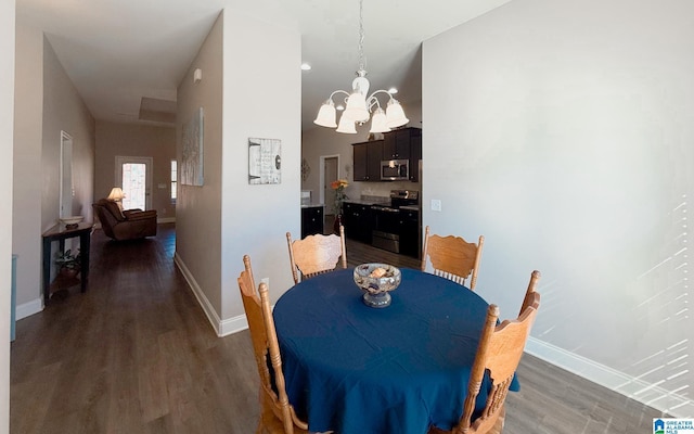 dining area with a chandelier and dark hardwood / wood-style floors