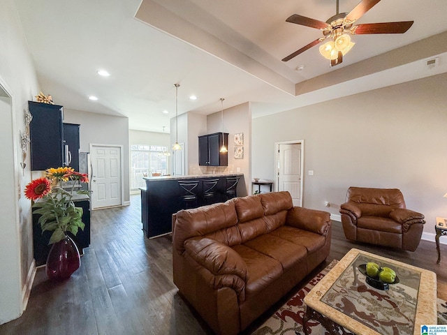 living room with dark hardwood / wood-style flooring and ceiling fan