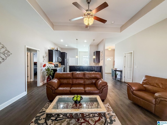 living room featuring ceiling fan and dark wood-type flooring