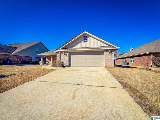 view of front of home with a front lawn, a garage, and cooling unit