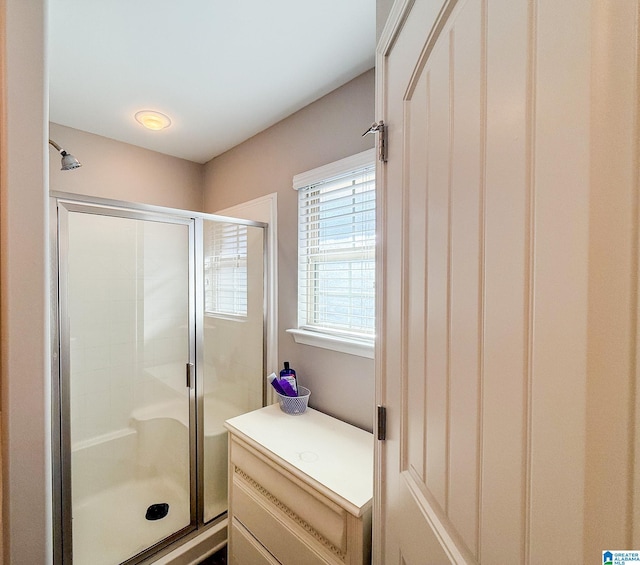 bathroom featuring a shower with door