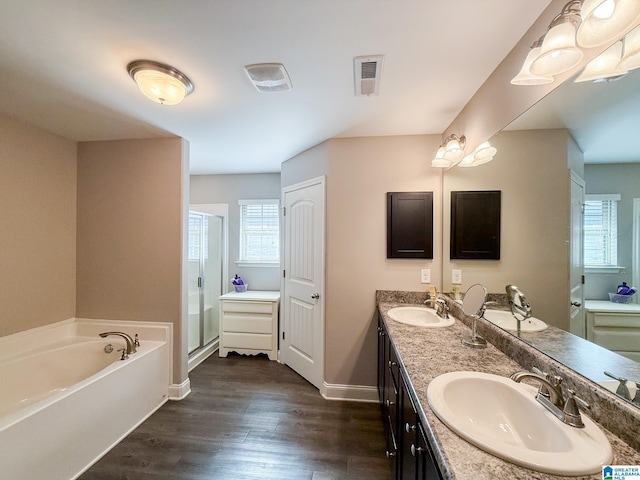 bathroom with hardwood / wood-style flooring, vanity, and separate shower and tub