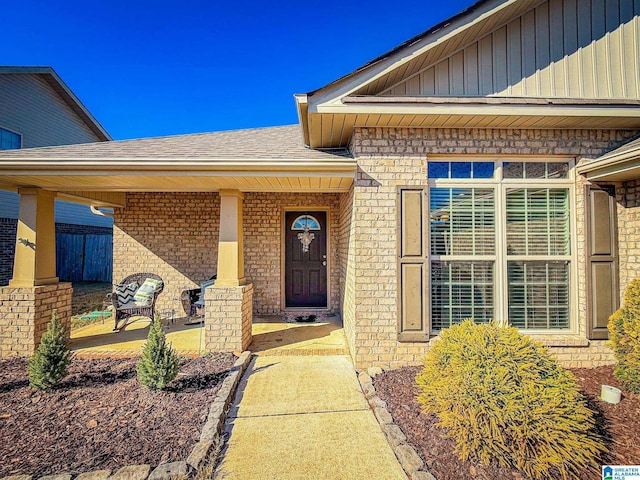 view of exterior entry featuring covered porch